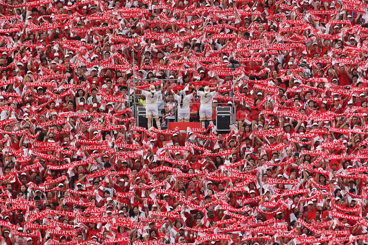People wave what's called the "Singapore scarf" during the National Day Parade on Aug. 9 in Singapore. Celebrations marked the island nation's 50th year of independence.