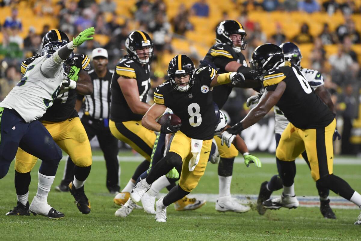 Pittsburgh Steelers quarterback Kenny Pickett (8) scrambles for a first down against the Seattle Seahawks during the second half of an NFL preseason football game Saturday, Aug. 13, 2022, in Pittsburgh. The Steelers won 32-25. (AP Photo/Barry Reeger)
