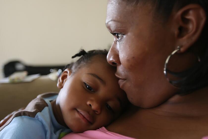 Darlene Compton cuddles with her son, Jontay who returned home after six months in foster care.