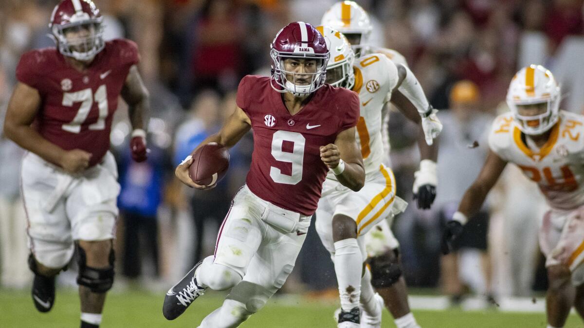 Alabama quarterback Bryce Young runs the ball against Tennessee.