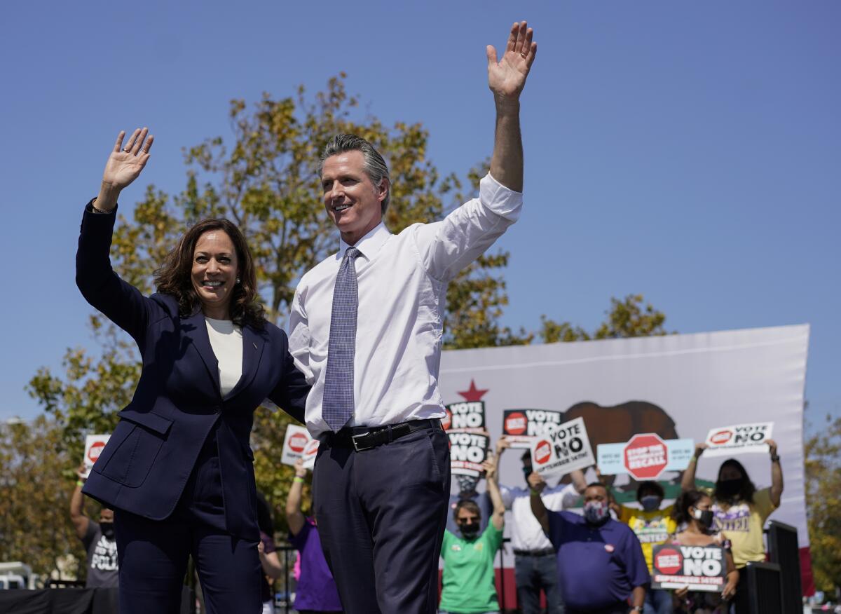 Vice President Kamala Harris stands on stage with California Gov. Gavin Newsom at the conclusion of an event at the IBEW-NECA Joint Apprenticeship Training Center in San Leandro, Calif., Wednesday, Sept. 8, 2021. (AP Photo/Carolyn Kaster)