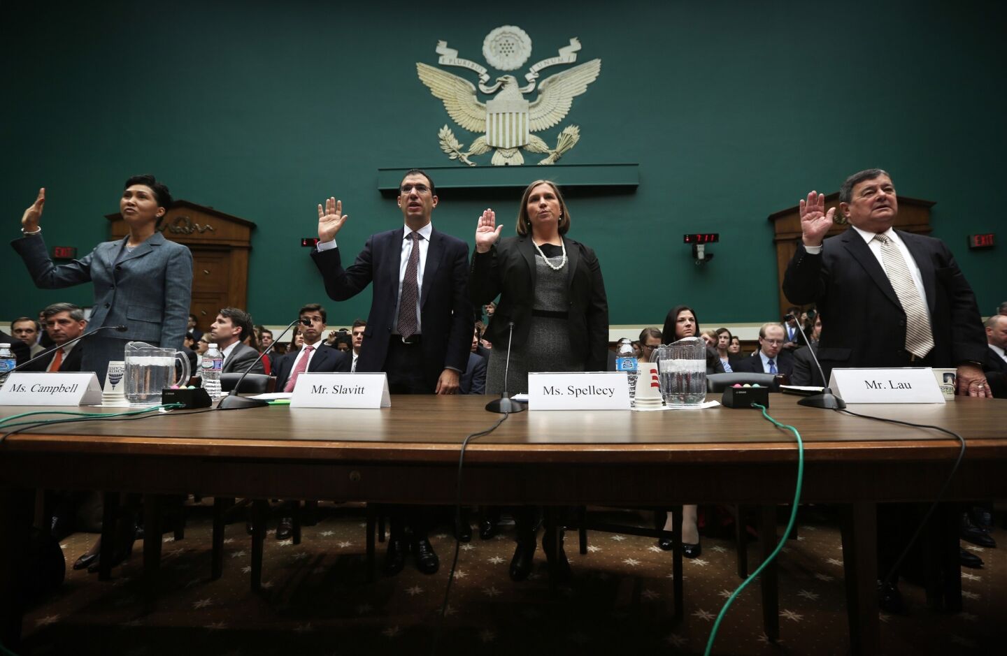 Cheryl Campbell, senior vice president of CGI Federal; Andrew Slavitt, group executive vice president for Optum/QSSI; Lynn Spellecy, corporate counsel for Equifax Workforce Solutions; and John Lau, program director for Serco, from left, are sworn in at a hearing on implementation of the Affordable Care Act before the House Energy and Commerce Committee.