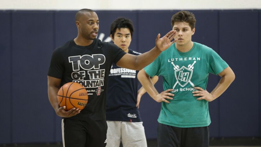 DJ Gay, who played basketball for San Diego State, oversees his Victory Christian Academy players at a practice when he was head coach there in December 2018.