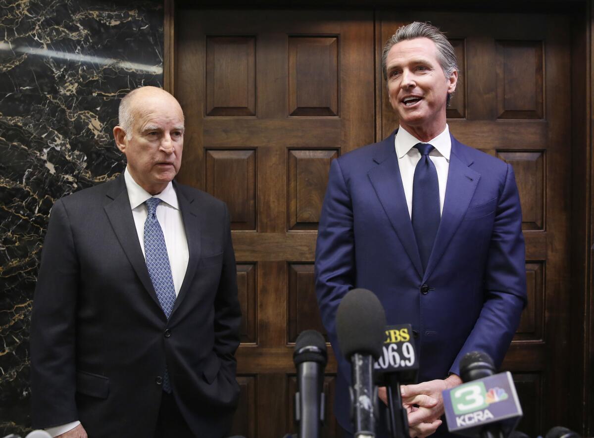 Gov. Jerry Brown, left, and Gov.-elect Gavin Newsom talk with reporters after their meeting at the state Capitol on Tuesday.