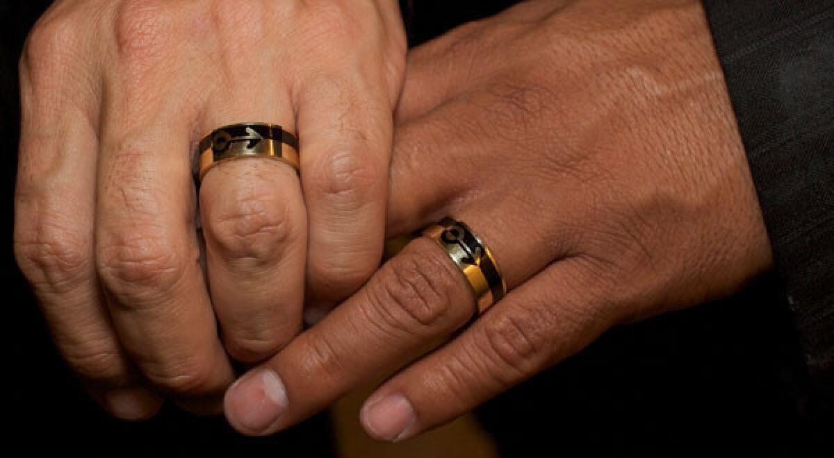 A same-sex couple hold hands as they get married in Los Angeles in 2008. Recently, Wyoming legislators have moved toward reaching a consensus on broadening domestic partnerships.