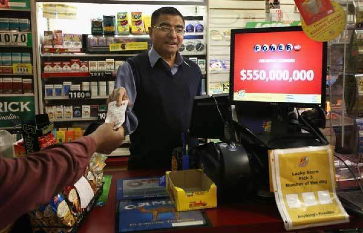 Gandhi Amrutlal sells a Powerball lottery ticket at his market in Chicago.