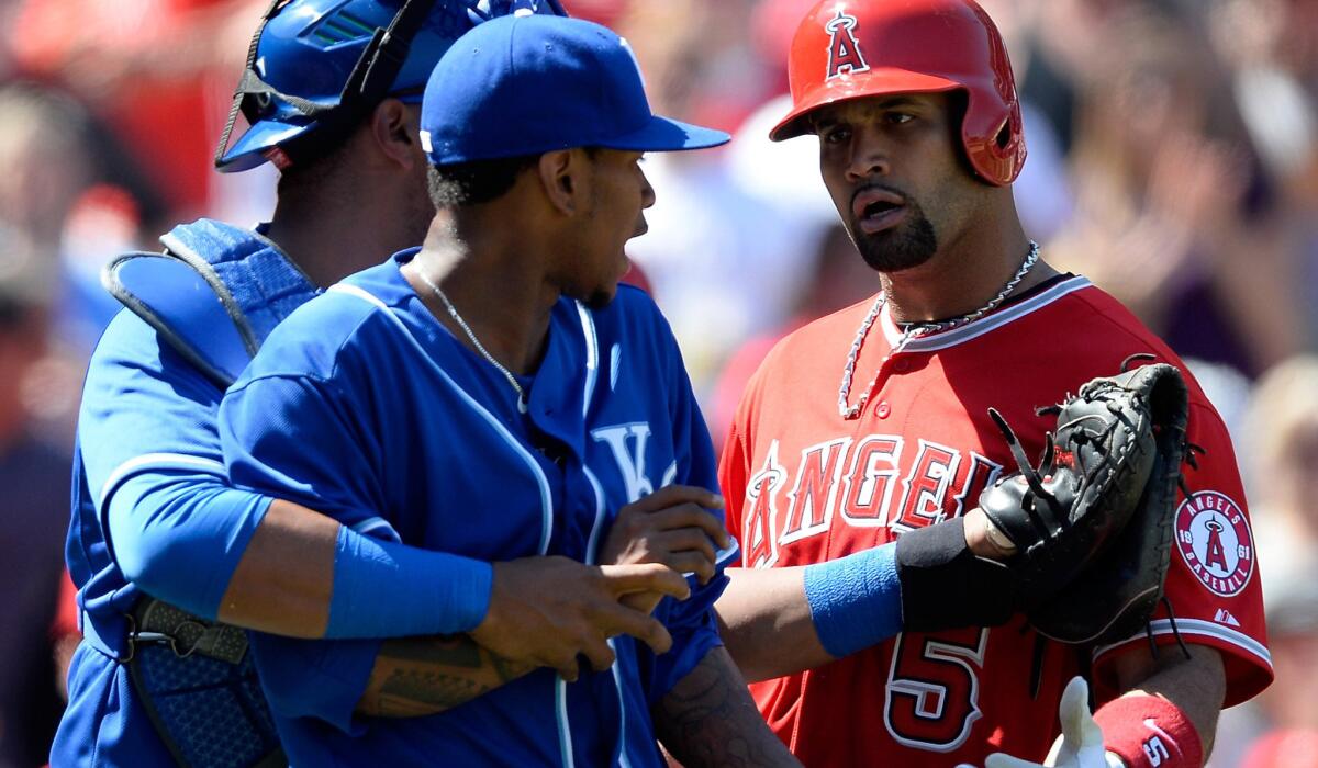 Angels slugger Albert Pujols is confronted by Royals pitcher Yordano Ventura, who is restrained by catcher Salvador Perez, after deliver a run-scoring single in the sixth inning Sunday.
