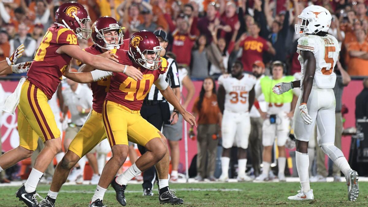 USC kicker Chase McGrath (40) is mobbed by teammates after kicking the game-winning field goal in overtime against Texas on Sept. 16.