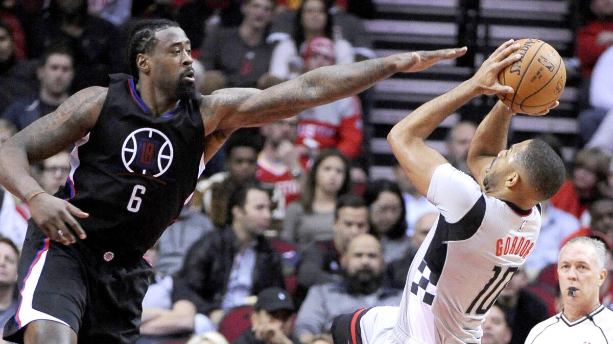 Clippers center DeAndre Jordan forces Rockets guard Eric Gordon to take a fadeaway shot in the lane during a game Dec. 30 in Houston.