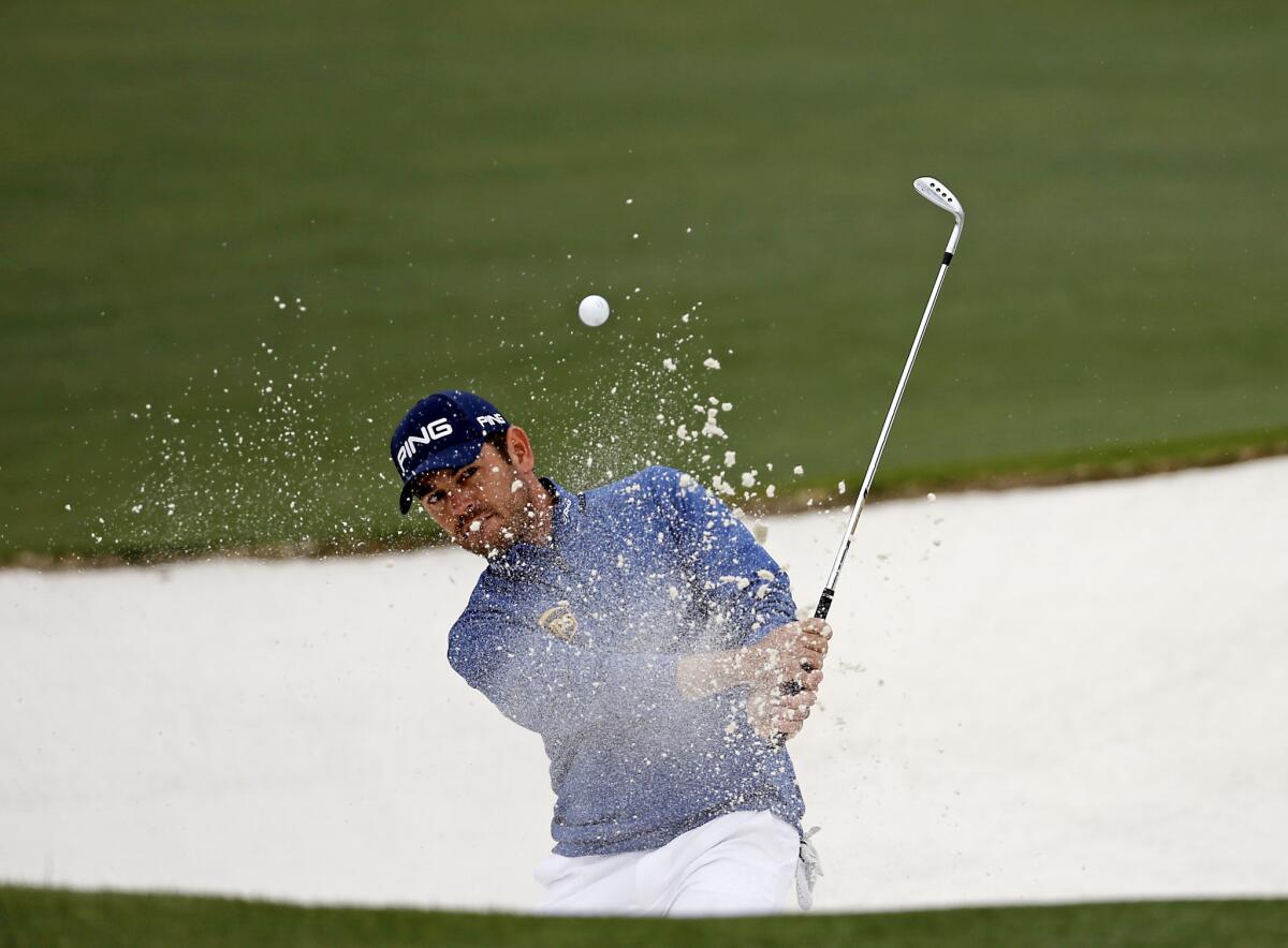 Louis Oosthuizen chips out of a bunker at the Masters on April 10.
