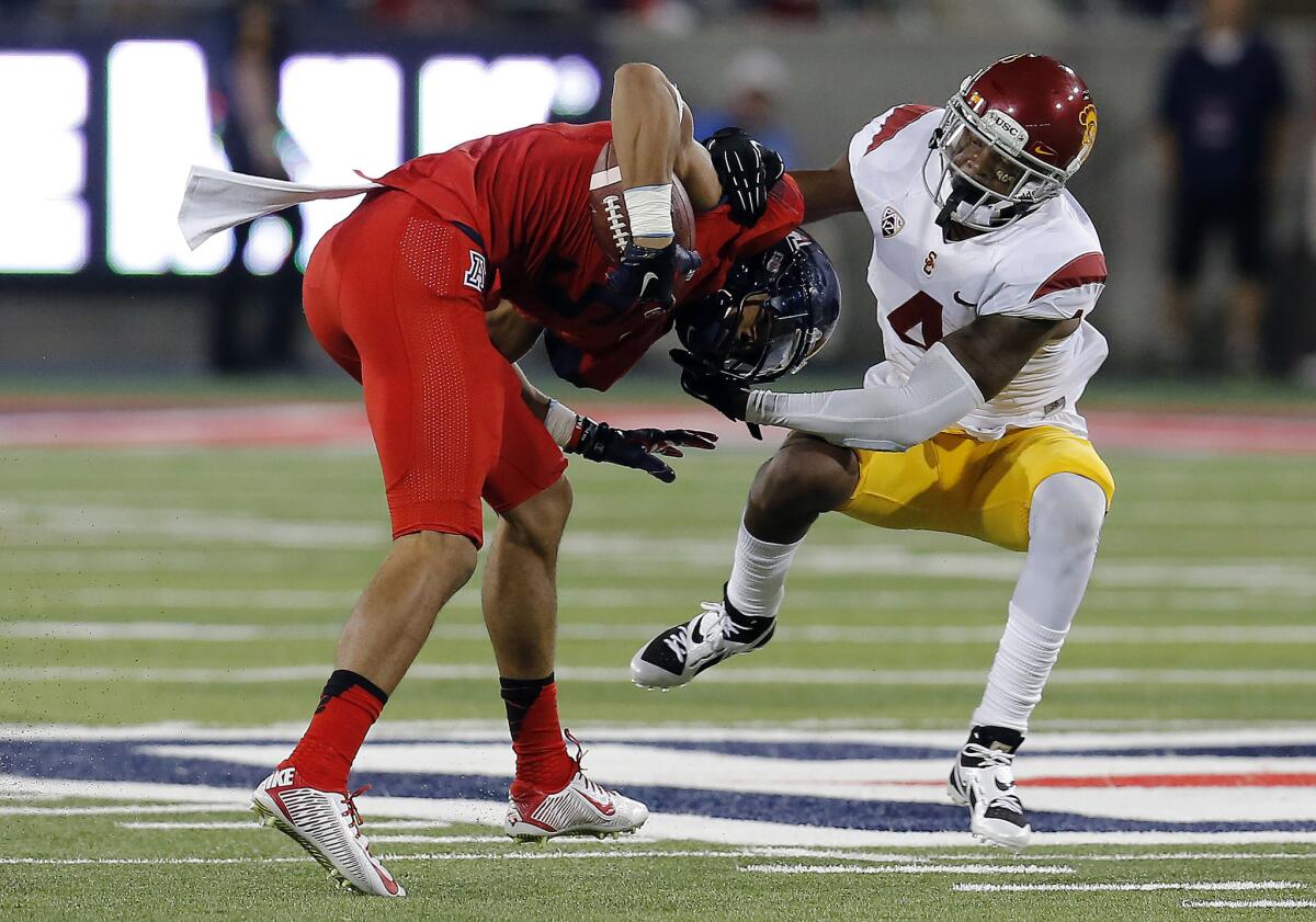 USC defensive back Chris Hawkins makes a tackle on an Arizona receiver during a game on Oct. 11. The Trojans beat the Wildcats, 28-26.