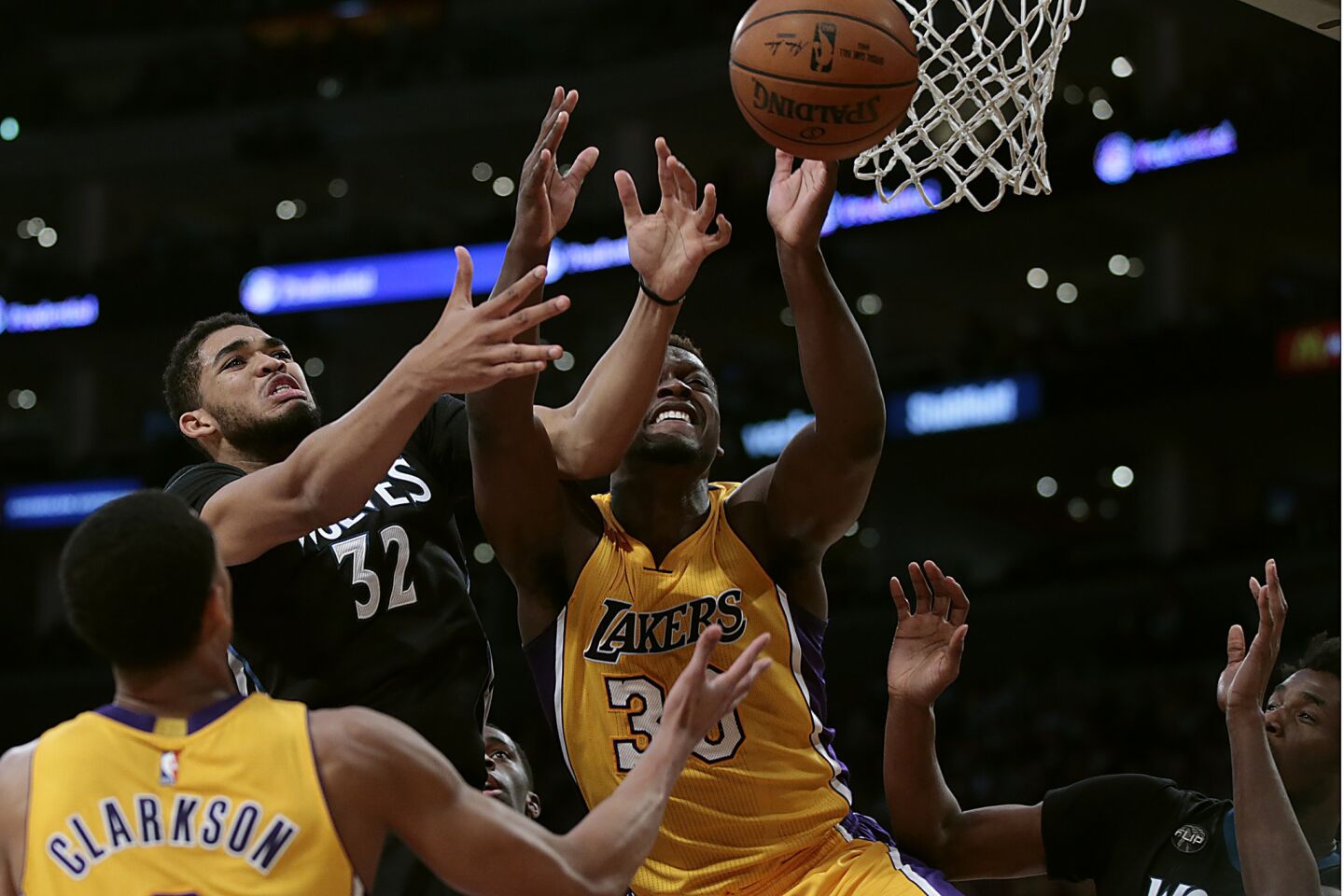 Lakers forward Julius Randle battles Timberwolves center Karl-Anthony Towns for a rebound during the second half of a game on Feb. 2 at Staples Center.