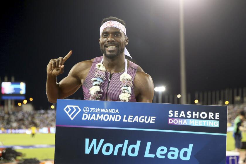 Kenneth Bednarek, of the United States, poses after winning the men's 200 meters during the Diamond League athletics meet at the Qatar Sports Club stadium in Doha, Friday, May 10, 2024. (AP Photo/Hussein Sayed)