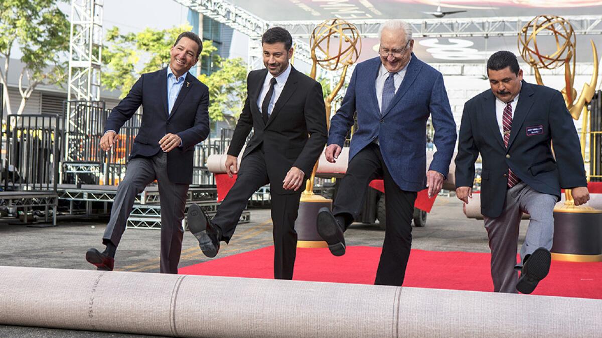 Emmy Awards host Jimmy Kimmel rolls out the red carpet with Television Academy Chairman/CEO Bruce Rosenblum, left, and executive producer Don Mischer and Television personality Guillermo Rodriguez during the 68th Primetime Emmy Red Carpet Rollout and Governors Ball Reveal.
