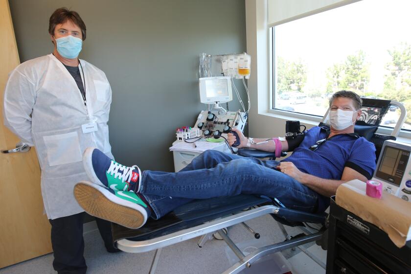 Glenn Walcott, 51 of Newport Beach, right, donated 840ml of plasma to San Diego Blood Bank during a 45-minute session at Hoag Health Center, on the 16,300 block of Sand Canyon Ave., in Irvine on Tuesday, April 28, 2020. Walcott has been identified as having the novel coronavirus COVID-19 (SARS-CoV2) antibodies after contracting the virus in March. He is now fully recovered. Phlebotomist Paul Posey, right, from the SDBB helped process the donation.