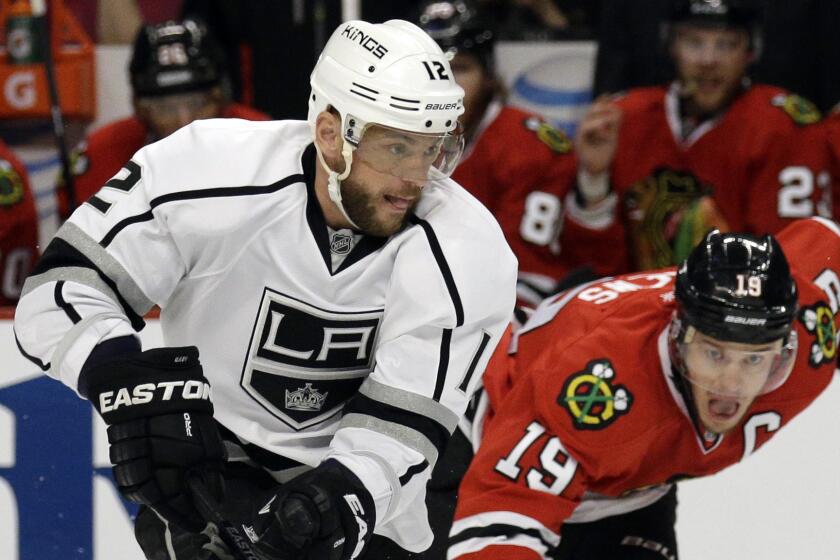 Kings forward Marian Gaborik, left, controls the puck in front of Chicago Blackhawks captain Jonathan Toews during the first period of the Kings' loss in Game 1 of the Western Conference finals Sunday. Gaborik has a league-leading nine goals in this year's playoffs.