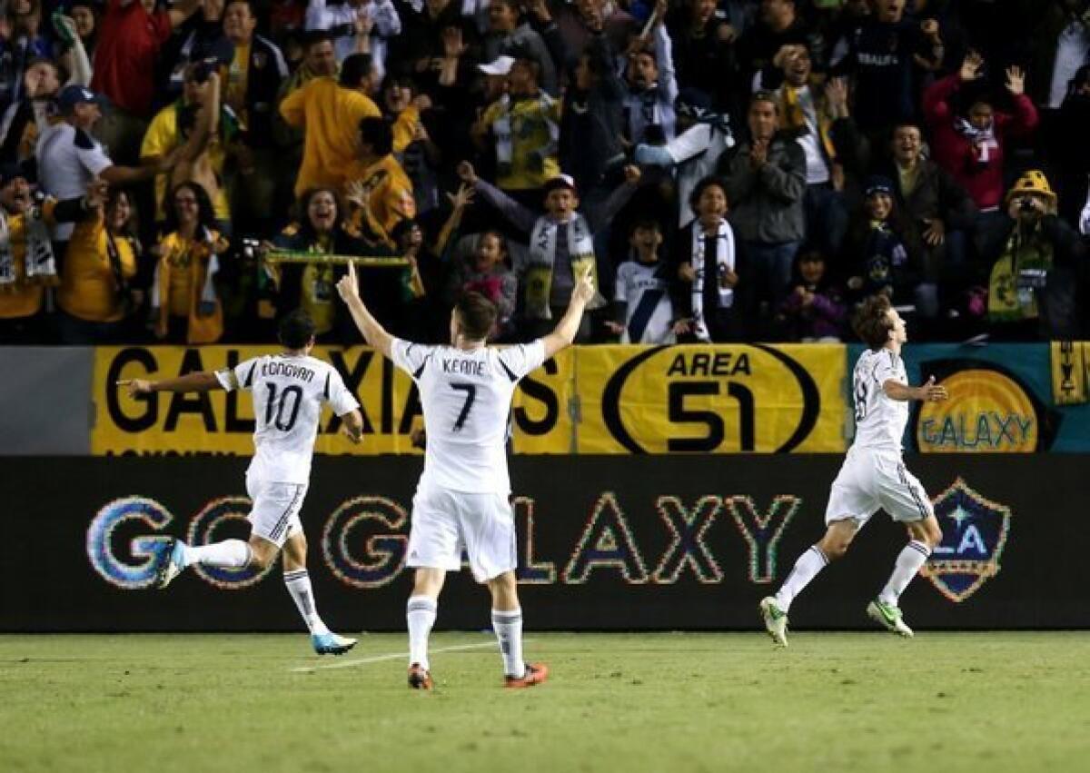 Landon Donovan, Robbie Keane and Mike Magee celebrate after Magee's goal against the Seattle Sounders in Game 1 of the Western Conference championship.
