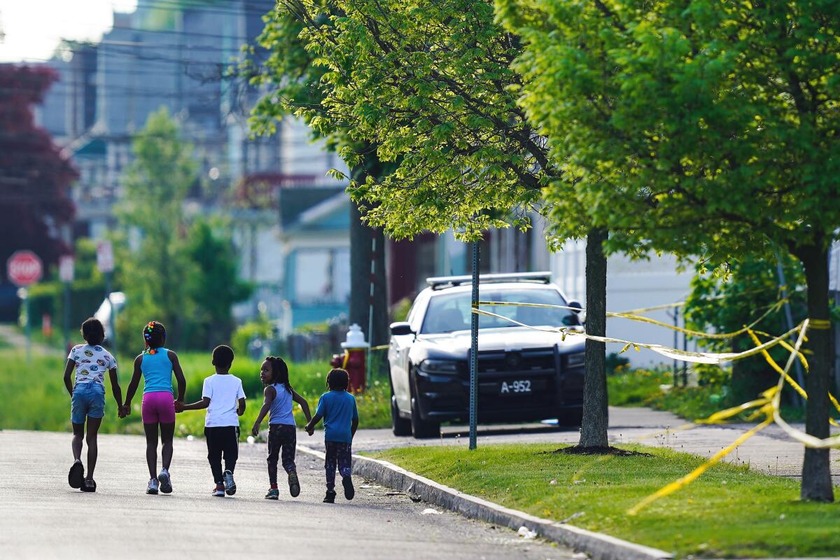 Children walk hand-in-hand