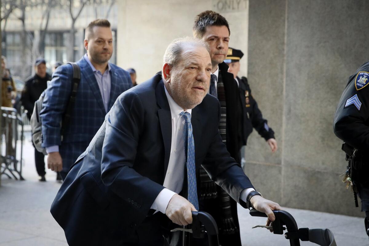 Harvey Weinstein uses a walker as he arrives at a Manhattan courthouse.