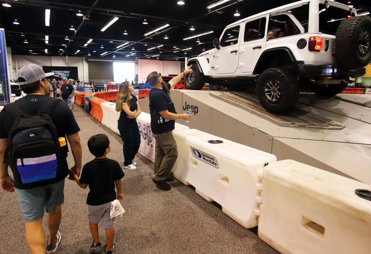 O.C. Auto Show attendees look at a Jeep.