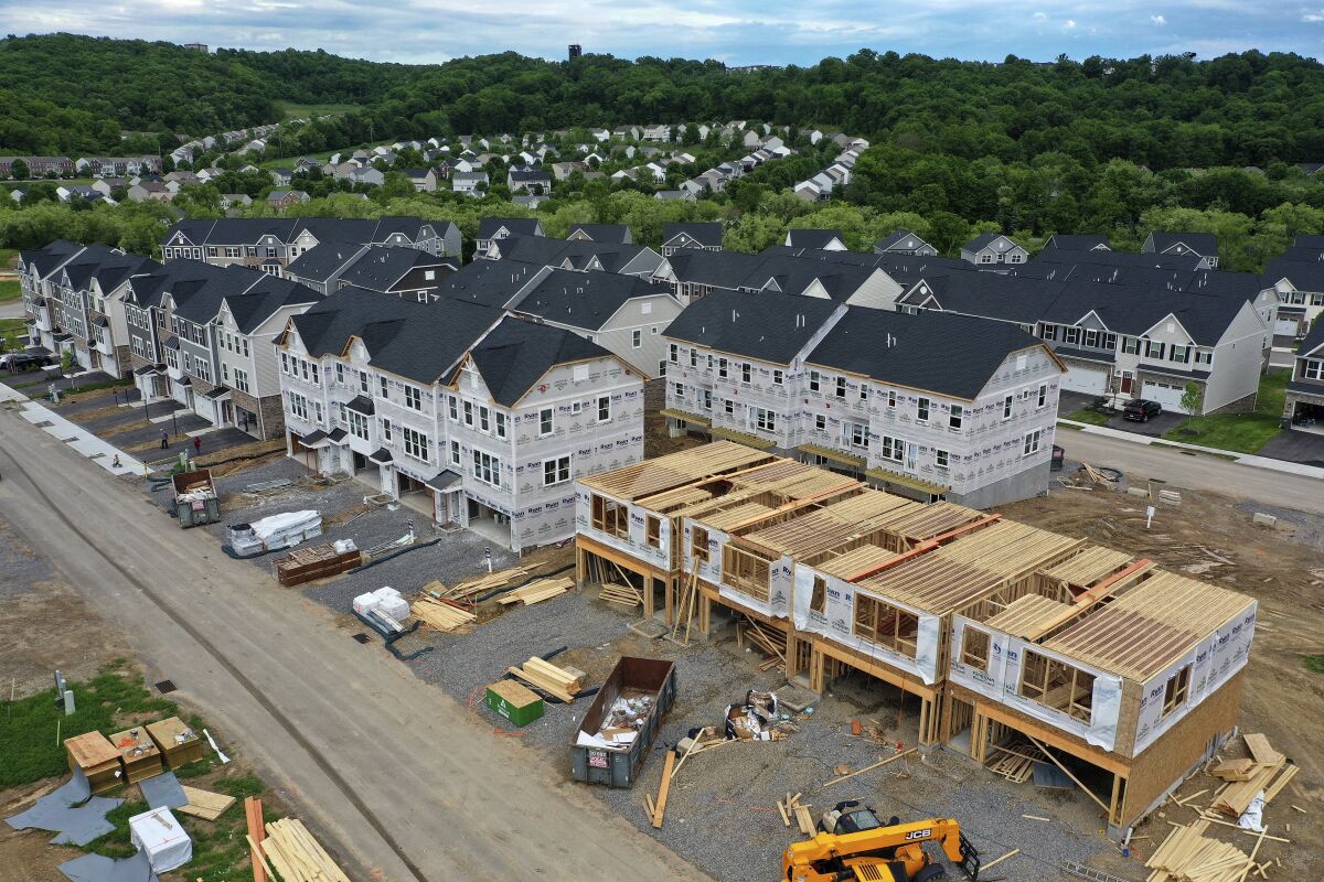 FILE - Houses under construction are seen in Mars, Pa., on May, 27, 2022. Homebuilders have pumped the brakes on new single-family home construction this year, a trend that’s likely to extend into 2023, according to several forecasts. (AP Photo/Gene J. Puskar, File)