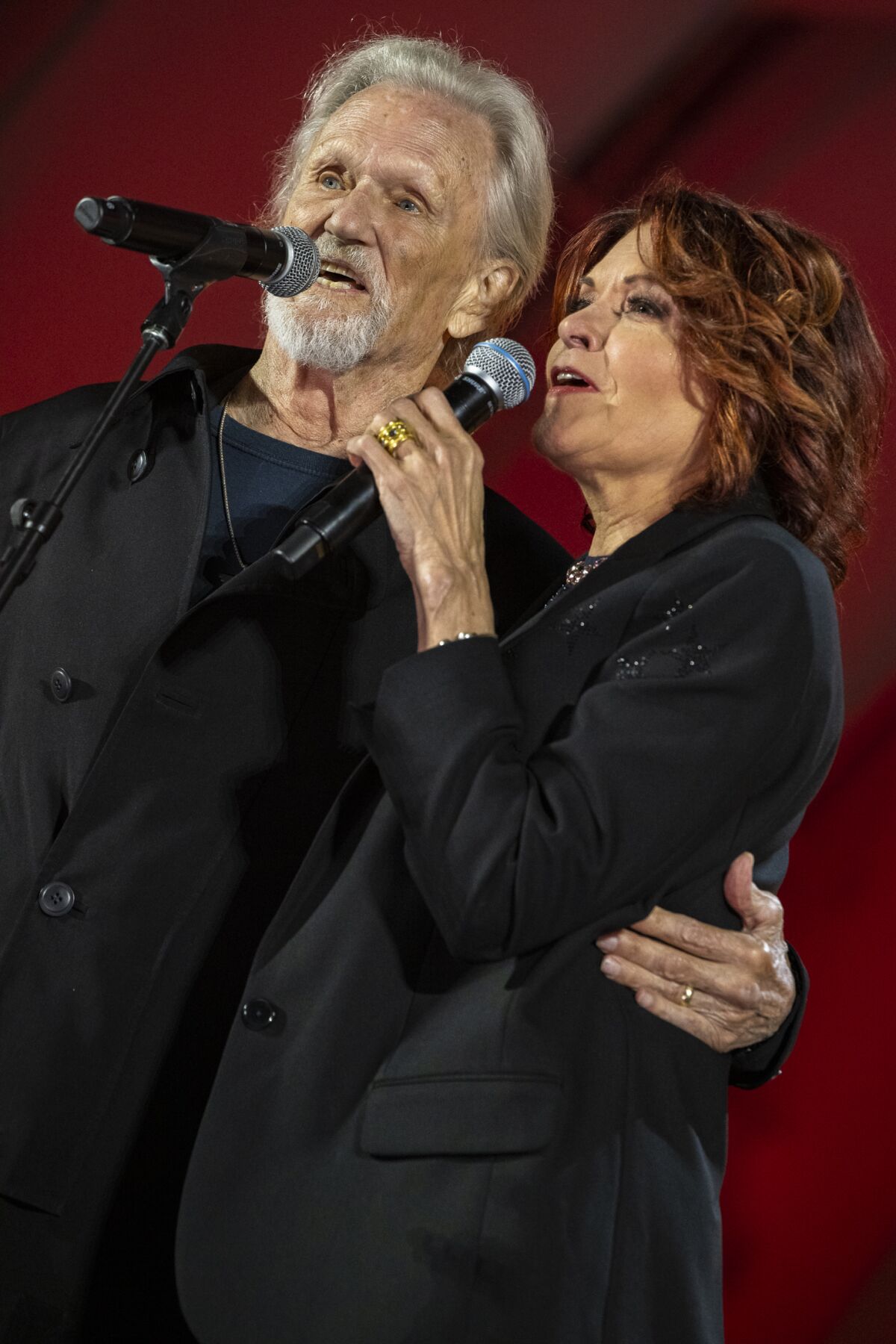 Kris Kristofferson and Rosanne Cash perform onstage