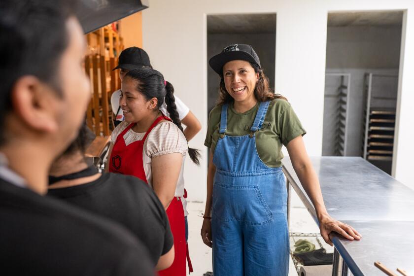 JOCOTENANGO, GUATEMALA - MAY 4, 2023: Chef Debora Fadul (right) laughs with staff and students at the cafeteria in El Patojismo, an alternative educational center for low-income urban youth. Chef Fadul teaches cooking courses at El Patojismo both for staff and students.