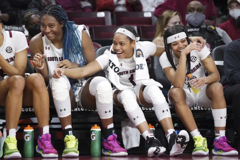 South Carolina guard Zia Cooke (1) Aliyah Boston, left, and Destanni Henderson, right, enjoy a big lead from the bench during the second half of an NCAA college basketball game against Alabama Thursday, Feb. 3, 2022, in Columbia, S.C. South Carolina won 83-51. (AP Photo/Sean Rayford)