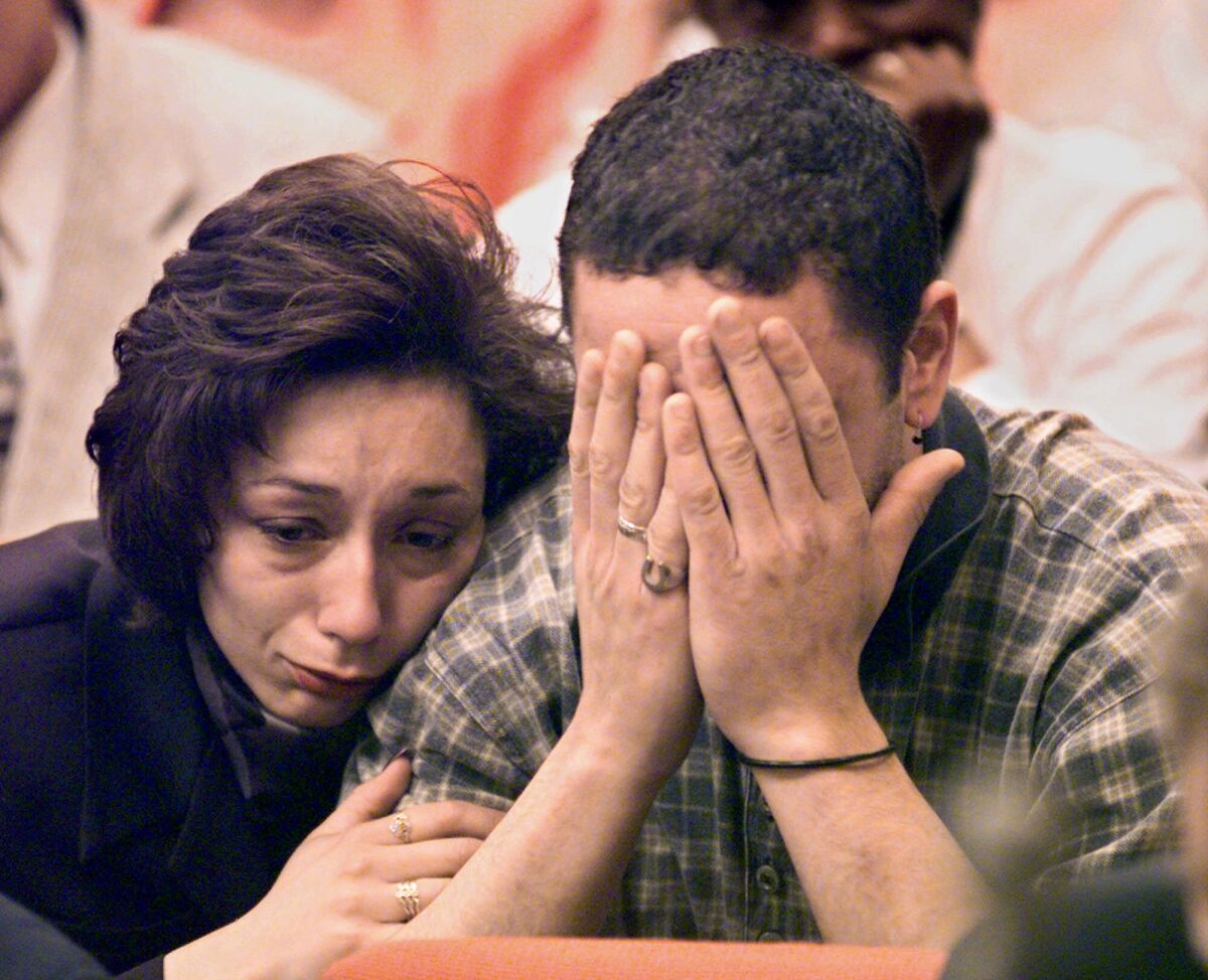 Dawn Babbitt Pezza comforts her brother, Manuel Babbitt Jr., at a clemency hearing for their father.