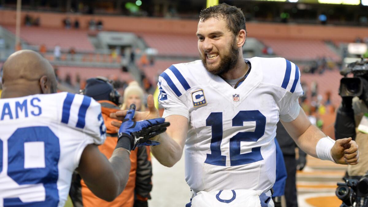 Indianapolis Colts quarterback Andrew Luck, right, celebrates with strong safety Mike Adams after a 25-24 comeback win over the Cleveland Brown. Next up for the Colts: a showdown with the Cowboys.