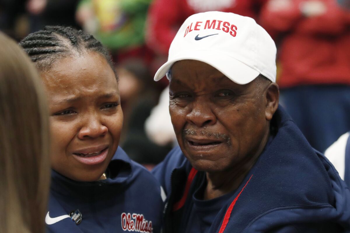Mississippi head coach Yolett McPhee-McCuin gets emotional with her dad Gladstone McPhee, right, after winning against Stanford during the second half of a second-round college basketball game in the women's NCAA Tournament, Sunday, March 19, 2023, in Stanford, Calif. (AP Photo/Josie Lepe)