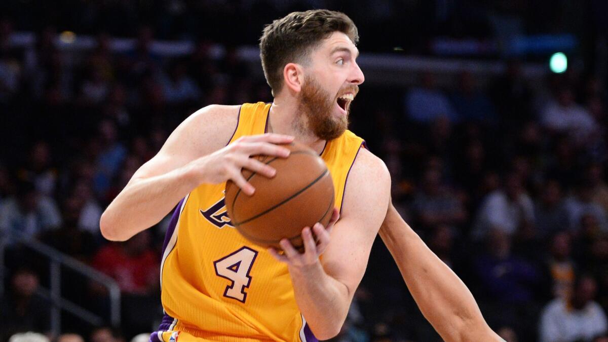 Lakers forward Ryan Kelly looks to pass during a game against the Detroit Pistons on March 10.