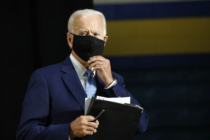 Former Vice President Joe Biden puts on a face mask after speaking in Wilmington, Del., on June 30.