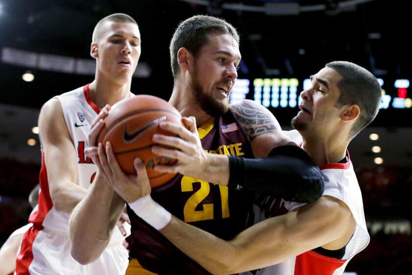 Arizona guard Gabe York tries to steal the ball from Arizona State forward Eric Jacobsen (21) in the first half of their game Sunday in Tucson.