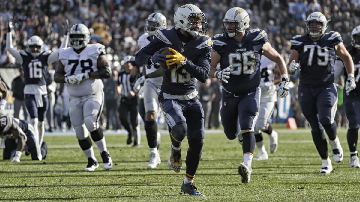 Chargers receiver Keenan Allen catches a fumbled ball from teammate Melvin Gordon and runs it into the endzone for a first quarter touchdown on Sunday against the Oakland Raiders.