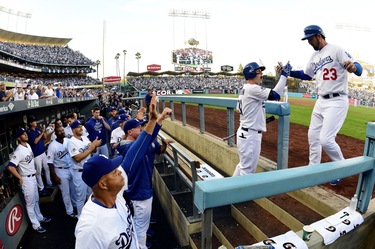 Dodgers first baseman Adrian Gonzalez celebrates with Joc Pederson after scoring a run in Game 5 of the National League Division Series on Oct. 15.