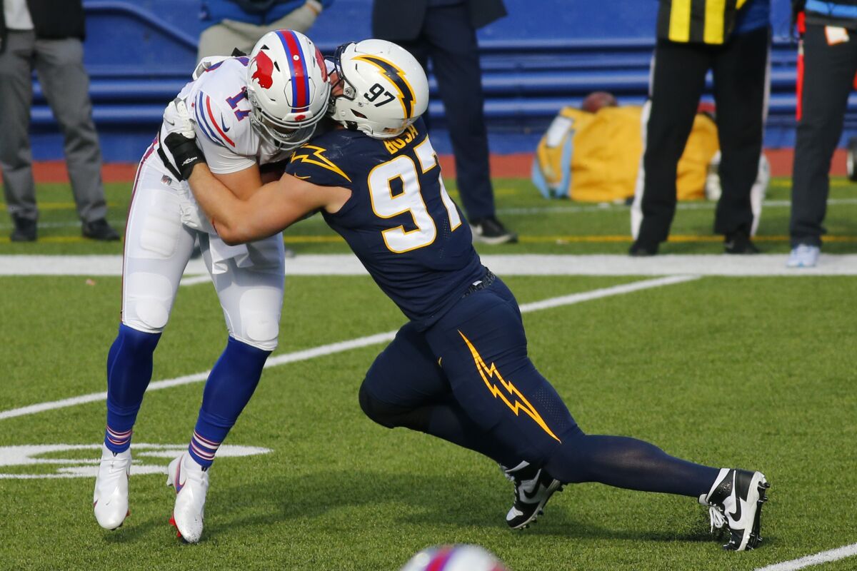Buffalo Bills quarterback Josh Allen is sacked by Chargers end Joey Bosa during the first half.