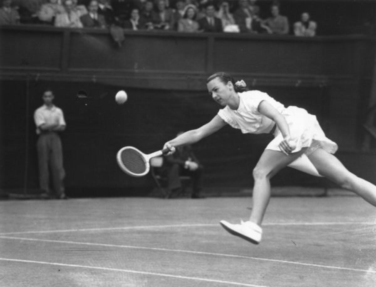 American tennis player Gertrude 'Gussie' Moran stretches for the ball during her match against E M Wilford of Great Britain at Wimbledon on June 22, 1949.