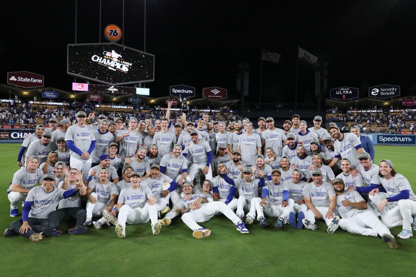 LOS ANGELES, CALIFORNIA - OCTOBER 20: The Los Angeles Dodgers pose for a team photo after defeating the New York Mets 10-5 in game six of the National League Championship Series to move onto the World Series at Dodger Field on Sunday, Oct. 20, 2024 in Los Angeles.(Robert Gauthier / Los Angeles Times)