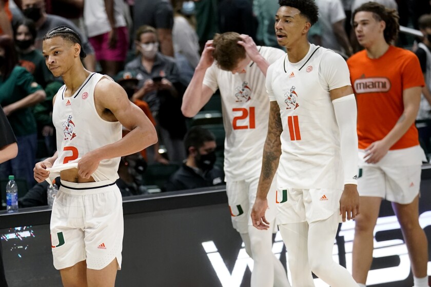Miami guard Isaiah Wong (2), forward Sam Waardenburg (21) and guard Jordan Miller (11) walk off the court after an NCAA college basketball game against Florida State, Saturday, Jan. 22, 2022, in Coral Gables, Fla. Florida State won 61-60. (AP Photo/Lynne Sladky)