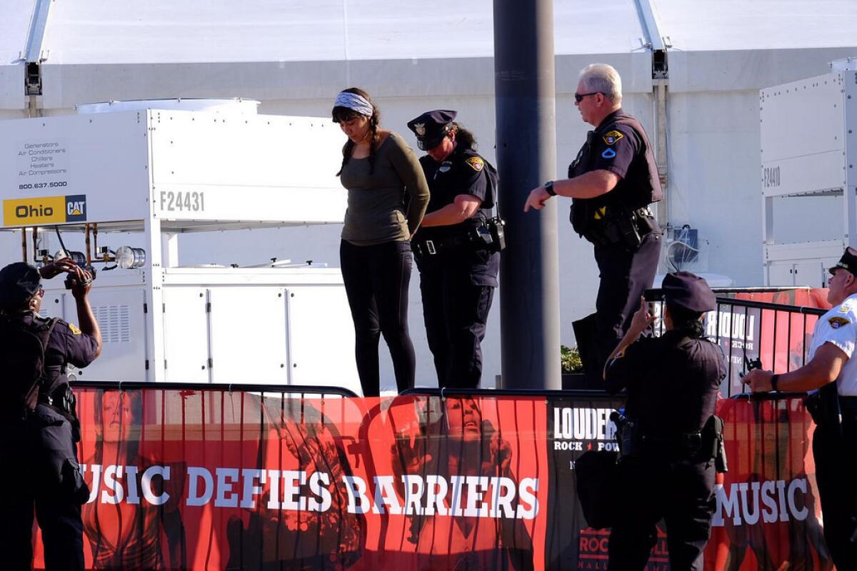 Activist Jacqui Zepeda of Los Angeles is arrested outside Cleveland's Rock and Roll Hall of Fame. (Collin Rees)