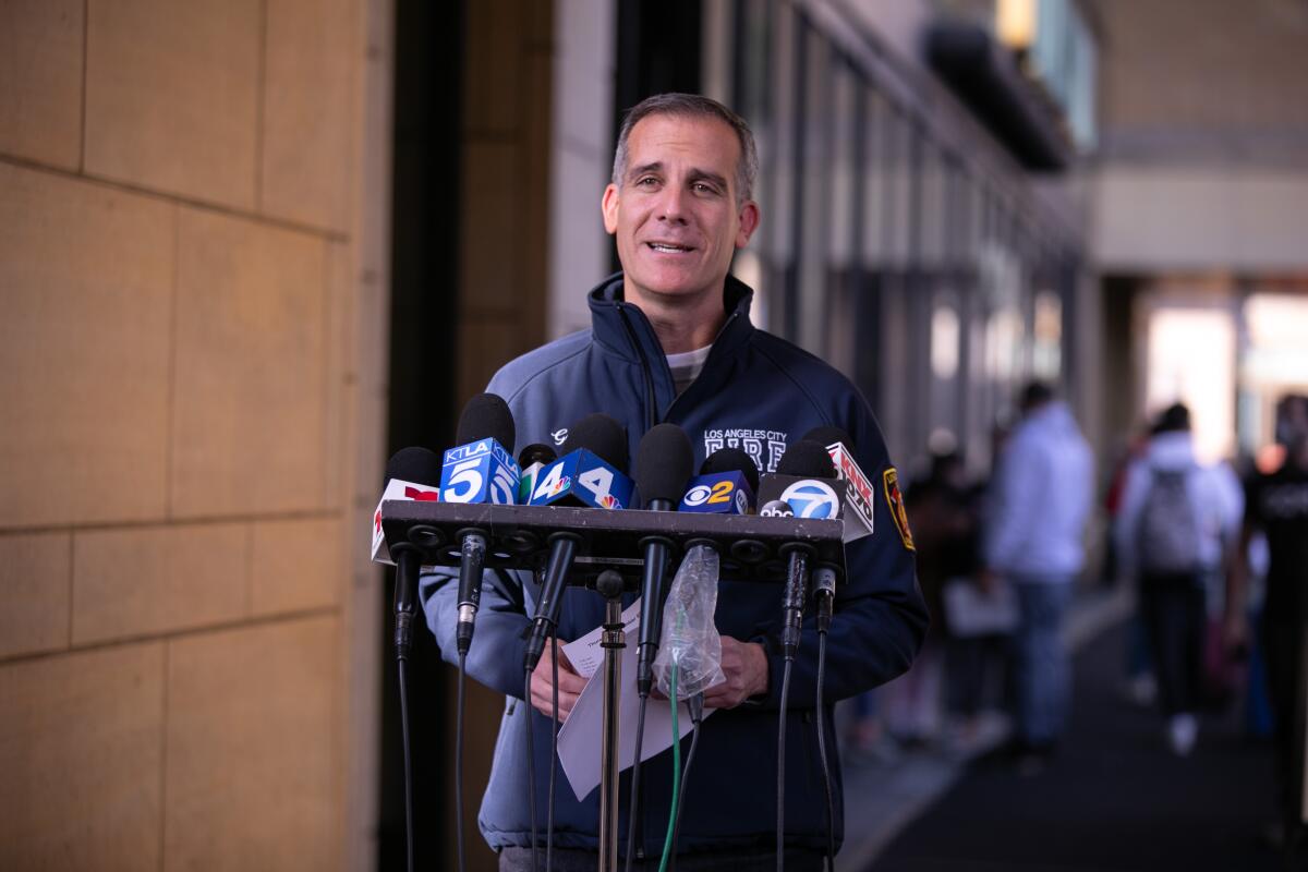 Mayor Eric Garcetti speaks into several microphones at Union Station.