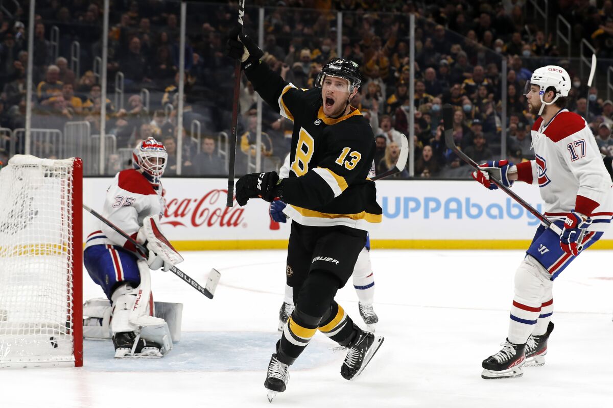 Boston Bruins' Charlie Coyle celebrates his second goal of the third period against Montreal Canadiens goaltender Sam Montembeault, left, during an NHL hockey game Sunday, Nov. 14, 2021, in Boston. (AP Photo/Winslow Townson)
