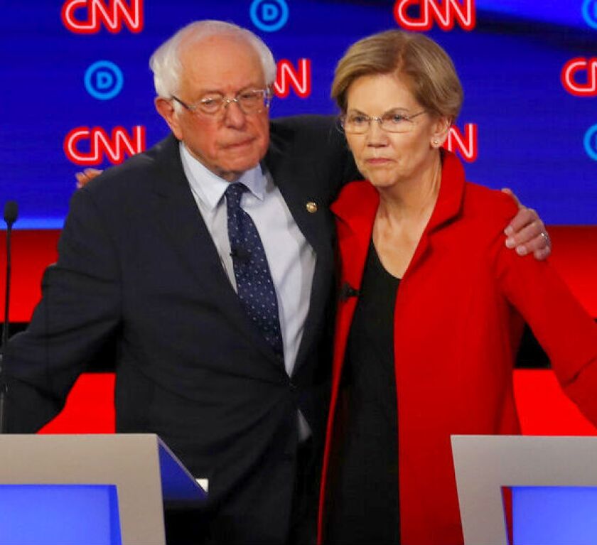 Sens. Bernie Sanders and Elizabeth Warren embrace after July 31 debate.