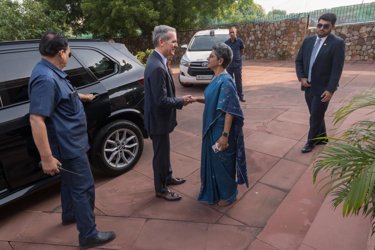 Eric Garcetti is greeted by Indrani Bagchi, chief executive of Ananta Center, in New Delhi.