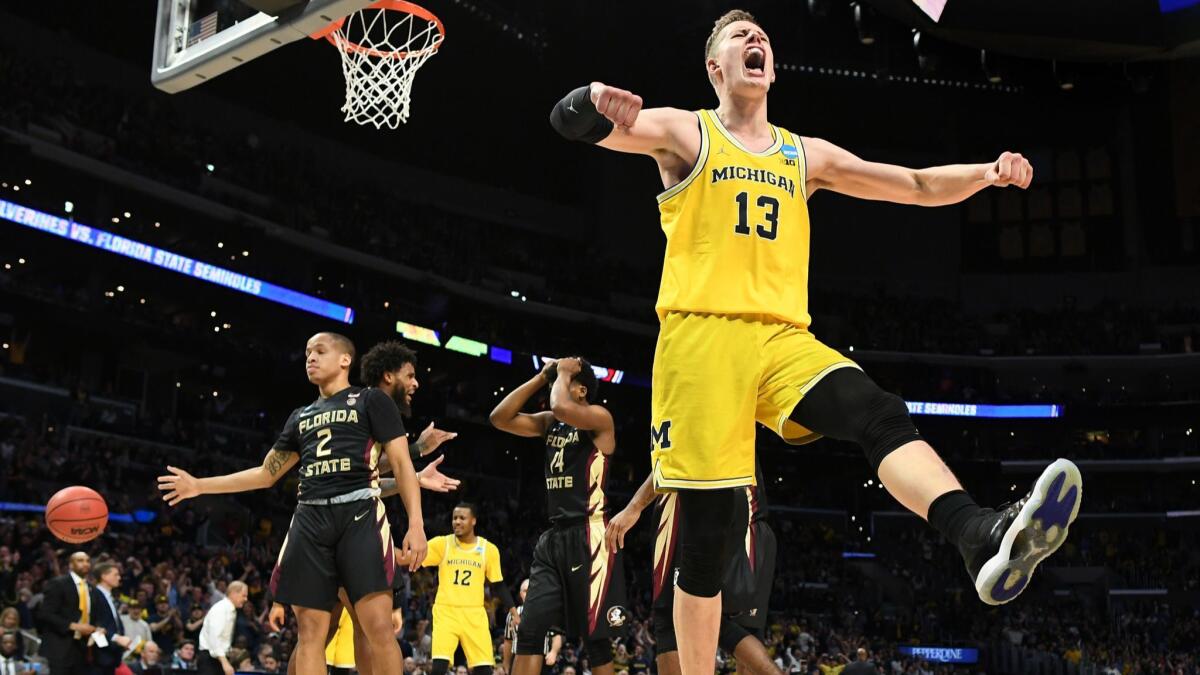 Michigan's Moritz Wagner celebrates his basket after being fouled by a Florida St. player.