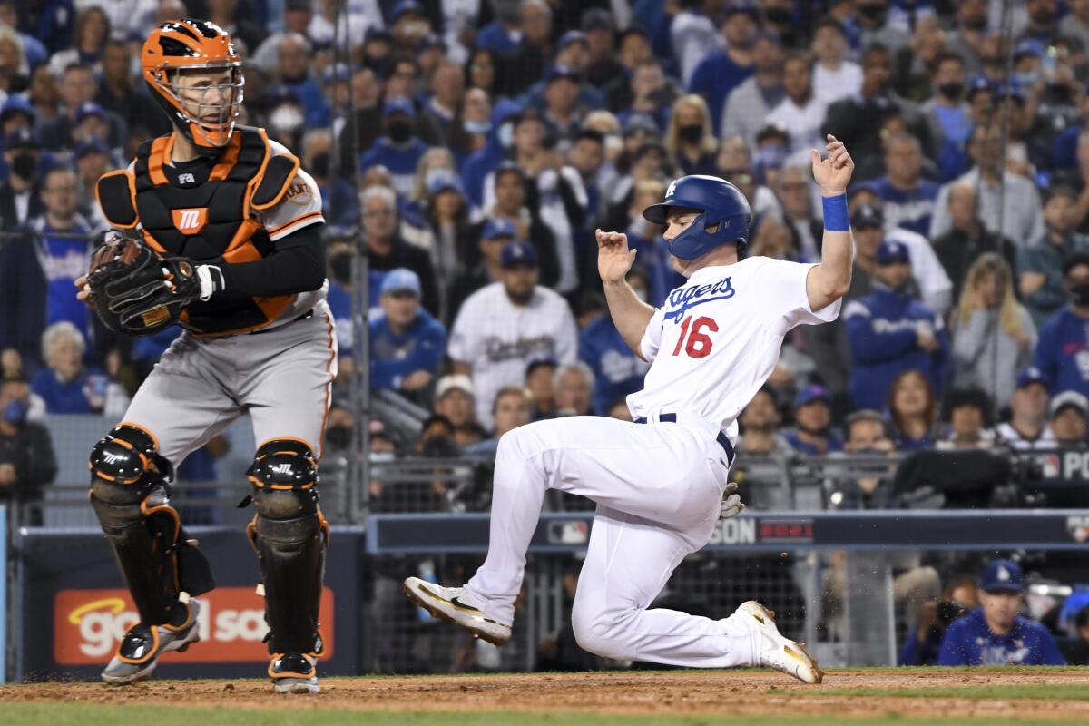 Dodgers baserunner Will Smith, right, is forced out at home by San Francisco Giants catcher Buster Posey.