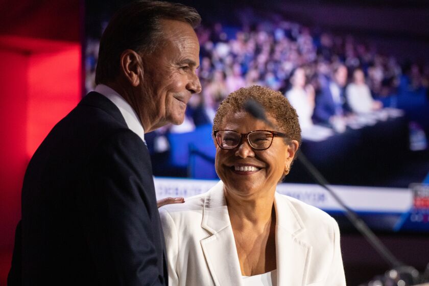 L.A. mayoral candidates Rick Caruso and Karen Bass after their debate on Wednesday.