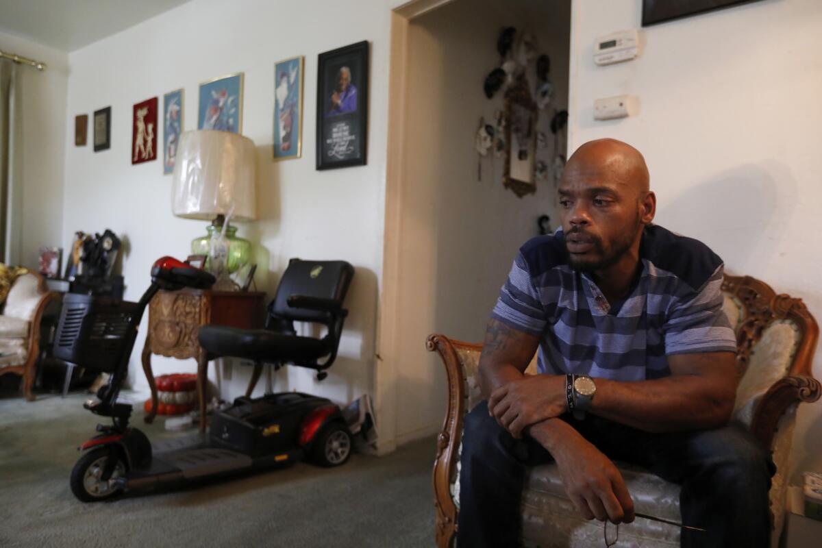 Zavion Johnson sits in his great-grandmother's Sacramento home. Johnson was exonerated in 2017 in the death of his daughter Nadia after spending 16 years in prison.