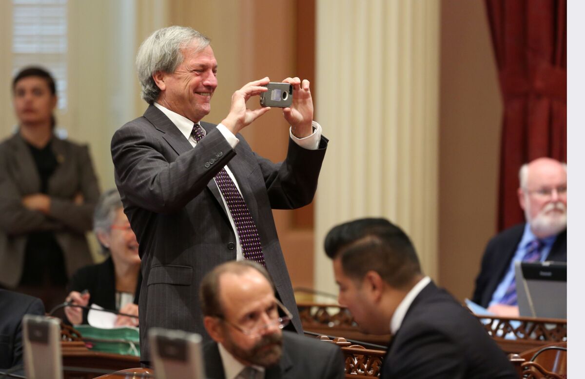 Then-state Sen. Mark DeSaulnier, D-Concord, takes a photo during the 2014 Senate session. DeSaulnier was diagnosed with leukemia shortly after being elected to Congress.